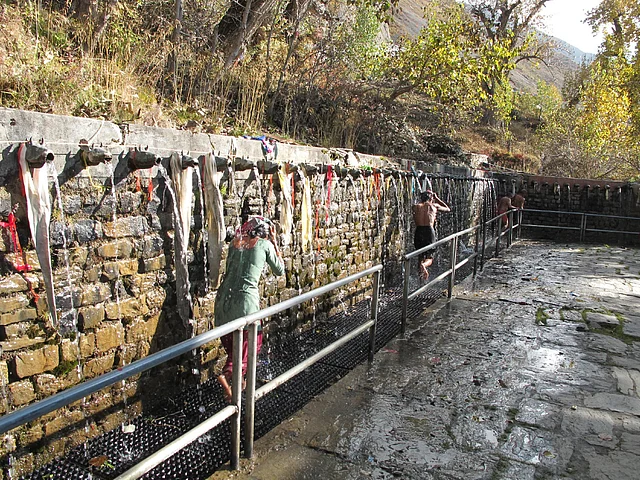 Pilgrims bathing under the water spigots at Muktinath.