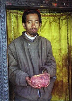 Hindu priest with a large shaligram at Vishnu Mandir – Muktinath.