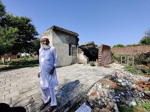 Saif Ali stands in front of the rubble of his daughter’s house. The house was one of many demolished in January 2022 in Paloura village, in Jammu district, after a land-regularisation law was repealed, leaving many families with uncertain futures. Photo courtesy: Rayan Naqash