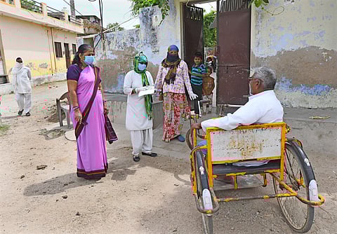 Health workers interact with a disabled man during a door-to-door survey in Beawar, Rajasthan. Despite government commitments to improve accessibility, disabled people in India face barriers ranging from damaged roads and broken lifts to steep steps and a lack of public toilets suitable for the disabled. Photo: IMAGO / Pacific Press Agency