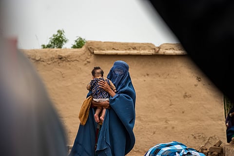 A woman and her baby in the village of Baghlan in Afghanistan, which was devastated by flash floods in May. A collapsing economy has left the impoverished and malnourished Afghan population poorly equipped to deal with natural disasters.