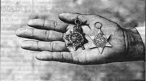 Palm facing up holding two medals.