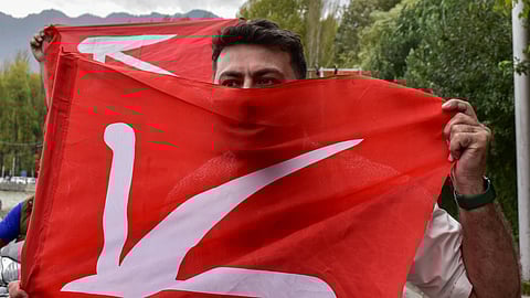 A supporter of Jammu and Kashmir National Conference party holds a party flag during celebrations after winning the assembly election. The Jammu and Kashmir National Conference and the Indian National Congress (INC) won the elections, a phenomenon occurring after 10 years in the region. The result is likely to mean challenges ahead for the national BJP government, particularly given that the new chief minister of Jammu and Kashmir, Omar Abdullah has voices support for restoring the territory’s statehood.