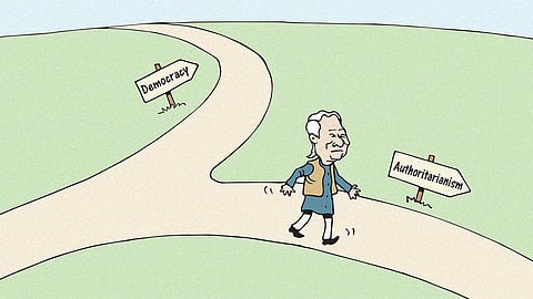 Cartoon of Bangladesh interim government head Muhammad Yunus walking along a path with the sign authoritarianism, with democracy in the other direction, after criticism over the interim government