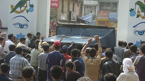 Nepal anti-monarchy protesters during Jana Andolan 2006 pushing over a tourist information centre in Boudha