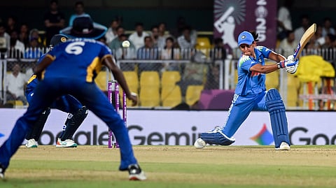 Photo of India women's cricket captain Harmanpreet Kaur batting as a Sri Lanka fielder looks on during ICC Women's Cricket World Cup 2025.