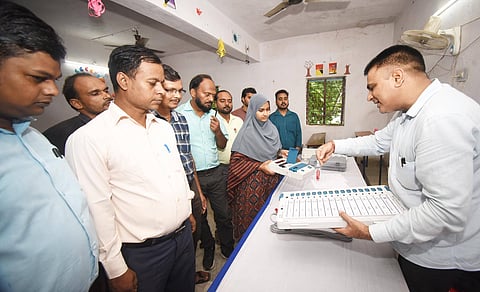Election officers in India demonstrate the Electronic Voting Machine at a training programme ahead of the Bihar assembly election.