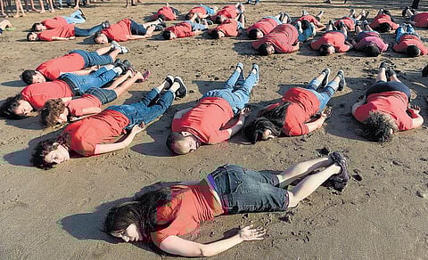 சடலமாக ஒதுங்கியது போன்று கிடந்து குழந்தை அய்லானுக்கு அஞ்சலி