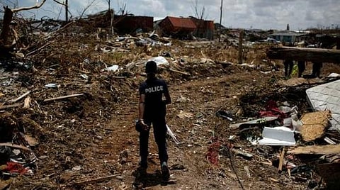 டோரியன் புயல், மார்ஷ் துறைமுகத்தில் உள்ள அபாகோ தீவுகளைத் தாக்கிய பின்னர், நேற்று முன்தினம் (செவ்வாய்க்கிழமை) அழிக்கப்பட்ட பகுதிகளில் இறந்தவர்களைத் தேடும் ஒரு போலீஸ் அதிகாரி.