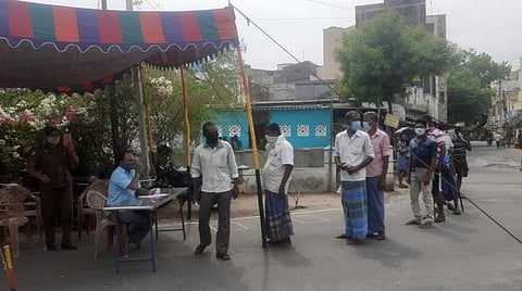 கரூர் மக்கள் பாதை பகுதியில் மது வாங்குவதற்கான டோக்கன் வழங்குமிடத்தில் வரிசையில் காத்திருந்து டோக்கன் வாங்கும் மதுவாங்க வந்த வாடிக்கையாளர்கள்.