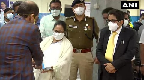 மக்களோடு வரிசையில் நின்று சுகாதாரக் காப்பீடு அட்டையைப் பெற்றுக்கொண்ட முதல்வர் மம்தா பானர்ஜி: படம் | ஏஎன்ஐ.