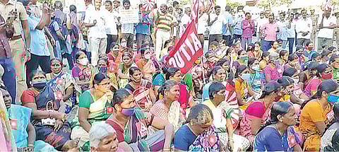 திருப்பூர் குமரன் நினைவகம் முன் நேற்று தர்ணா போராட்டத்தில் ஈடுபட்ட தொழிலாளர்கள்.