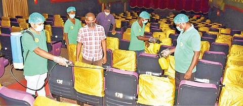 கடலூரில் ஒரு திரையரங்கில் கிருமிநாசினி தெளிக்கப்படுகிறது.