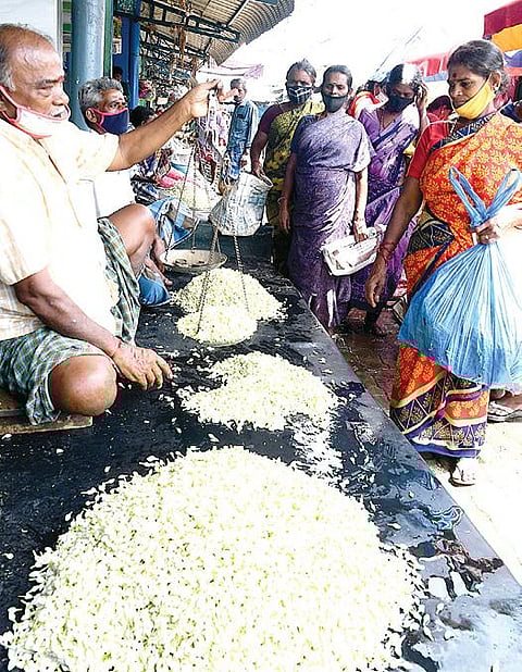 மாட்டுத்தாவணி சந்தையில் விற்பனைக்கு குவிக்கப்பட்டுள்ள மதுரை மல்லிகை. படம்: ஜி.மூர்த்தி