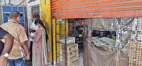 கோவை லாலி ரோட்டில் பணம் திருட்டு போன டாஸ்மாக் கடையில் விசாரணை நடத்தும் போலீஸார். படம்: ஜெ.மனோகரன்