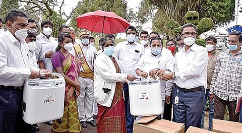 உதகையில் டிவிஎஸ் அறக்கட்டளை சார்பில் வழங்கப்பட்ட ரூ.25 லட்சம் மதிப்பிலான ஆக்சிஜன் செறிவூட்டிகளை அரசு மருத்துவக் கல்லூரி டீன் மனோகரியிடம் நேற்று வழங்கிய வனத் துறை அமைச்சர் கா.ராமச்சந்திரன் உள்ளிட்டோர். படம்: ஆர்.டி.சிவசங்கர்