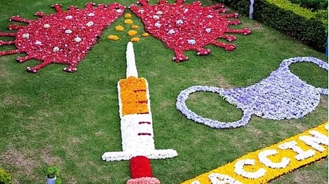 கொடைக்கானல் பிரையண்ட் பூங்காவில் விழிப்புணர்வுக்காக மலர்களால் வடிவமைக்கப்பட்டிருந்த முகக்கவசம், தடுப்பூசி, கரோனா வைரஸ் மாதிரிகள்.