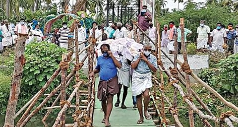 கோபி அருகே இறந்தவரின் சடலத்தை அடக்கம் செய்ய, கீரிப்பள்ளம் ஓடையில் தற்காலிக பாலம் அமைத்து எடுத்துச் செல்லும் பொதுமக்கள்.