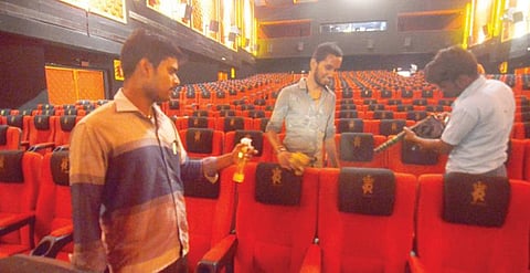 திருநெல்வேலியில் உள்ள திரையரங்கில் சுத்தம் செய்யும் பணியில் ஈடுபட்ட ஊழியர்கள். படம்: மு.லெட்சுமி அருண்