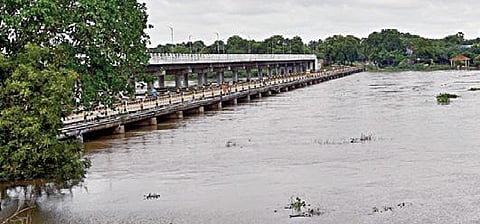 தாமிரபரணி ஆற்றில் முக்காணி - ஆத்தூரை இணைக்கும் பாலத்தை தொட்டபடி வெள்ளம் பாய்கிறது. படம்: என்.ராஜேஷ்.