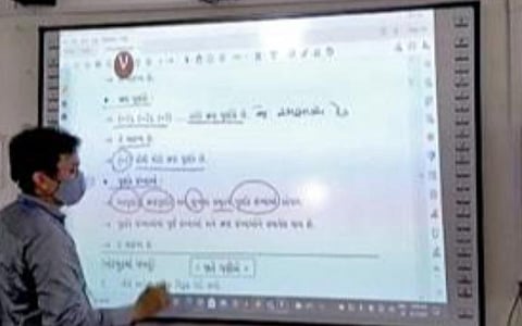 சூரத் அரசு பள்ளி ஒன்றில் ஸ்மார்ட் போர்டில் பாடம் நடத்தும் ஆசிரியர்