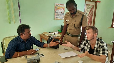 மகா தீபம் ஏற்றப்படும் அண்ணாமலையை தடை உத்தரவை மீறி ட்ரோன் கேமரா மூலம் படம் பிடித்த ரஷ்ய நாட்டைச் சேர்ந்த செர்ஜியிடம் விசாரணை நடத்திய திருவண்ணாமலை வனச்சரக அலுவலர் ஸ்ரீநிவாசன்.