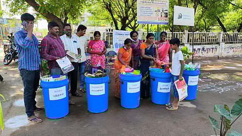 சிவகங்கை காந்திவீதி ராமச்சந்திரனார் பூங்கா அருகே பழைய பொருட்களை பெறும் நகராட்சி ஊழியர்கள்.