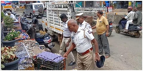 கூடலூரில் கஞ்சா விற்பனை செய்து வந்த நடைபாதை கடையை அப்புறப்படுத்தும் போலீஸார்