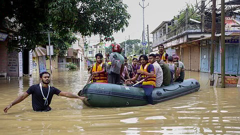 திரிபுராவில் ரப்பர் படகு மூலம் மீட்கப்பட்ட மக்கள்.