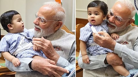 சின்னஞ்சிறு நண்பனுடன் பிரதமர் மோடி: சமூக வலைதளங்களில் வைரலாகப் பரவும் புகைப்படம்