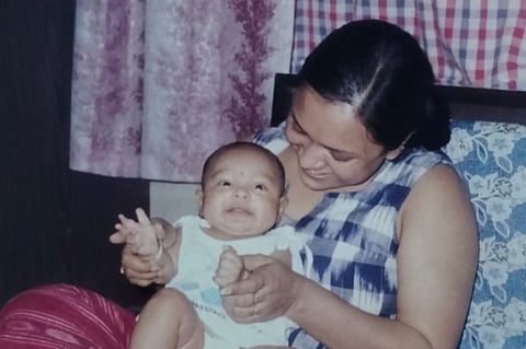 A mother joyously holding her child.