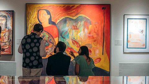 Visitors discussing a painting at MAP