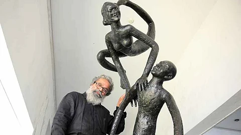 KS Radhakrishnan posing with one of his sculptures