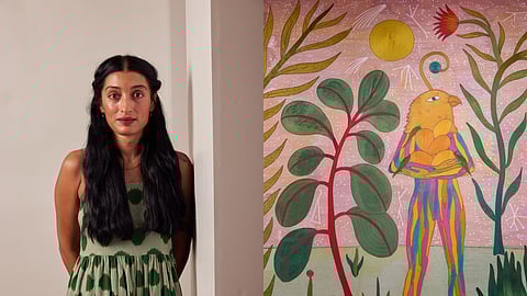 'Rithika Merchant and her painting, 'The Flowers We Grew'.