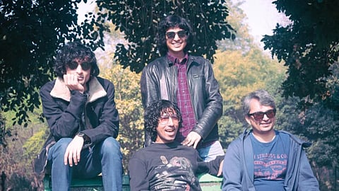 A casual image of the four-piece Delhi rock outfit Purple Cassette posing outdoors in a park setting.