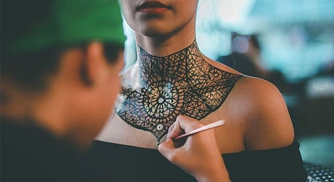 Ava paints the throat chakra choker