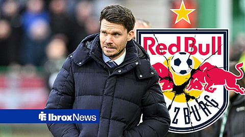 Danny Rohl, stood in front of a cracked Red Bull Salzburg badge