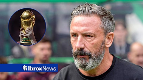 An unidentified player holding the World Cup trophy, with Derek McInnes of Heart of Midlothian during the William Hill Premiership match at Celtic Park, Glasgow 16/05/2026.