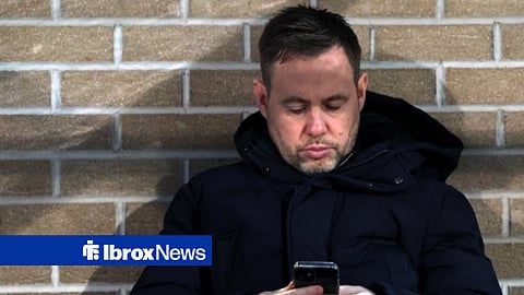 Michael Beale using his phone