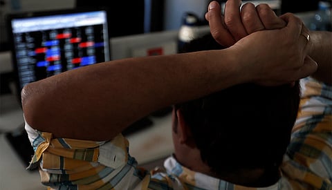 Sensex, Nifty fall from record highs as banks drag