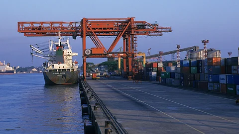 A container ship is being unloaded in the port of Cochin in India. The Indian government’s decision to approve a subsidy scheme to Indian shipping companies in global tenders for import of government cargo, will make it attractive to register ships in India.