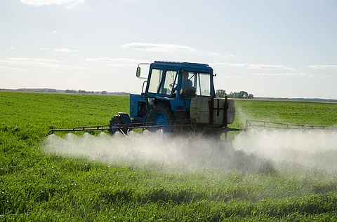 Tractor spraying pesticides in the field (Image: Aqua Mechanical)