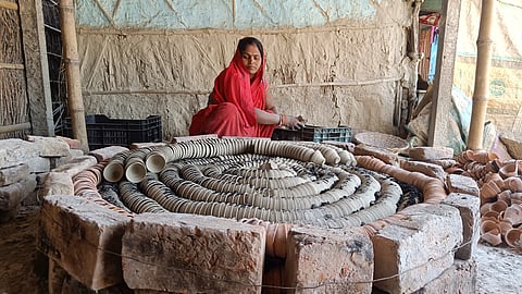 Babita Devi prepares the furnace carefully, placing bricks in perfect alignment. This helps spread heat evenly so that the kulhads (clay cups) become strong and don’t crack during firing.