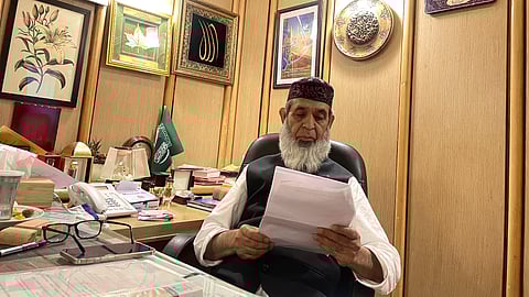 Focused on his work, Manzoor Wangnoo sits at his desk. Behind every restored spring and clean lake are countless hours of planning, coordination, and unwavering dedication.