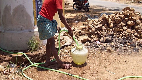 Farmer taking water from a hand pump (Source: IWP Flickr photos)