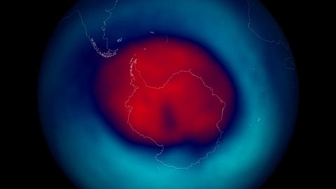 Edited NASA PR image showing the ozone hole for 2014 over the south pole. Red is bad, blue is good, e.g., red means not as much ozone as blue. (Image: Stuart Rankin; CC BY-NC 2.0)