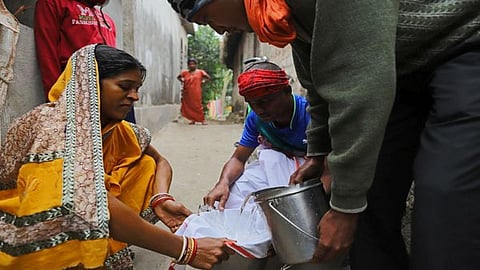 Shantilata uses a cloth to filter out the high iron content in the salty water, filled from a hand pump, in the village Sitapur on the outskirts of Bhadrak, Bhubaneshwar, Odisha (Image: WaterAid/ Anindito Mukherjee)