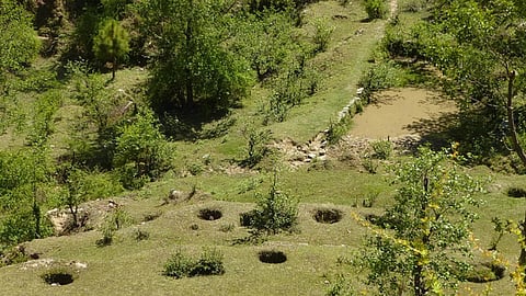 A traditional system practised in Uttarakhand, the circular pits on the slopes store rainwater and allow it to slowly percolate to the drain line, where water is stored in the pond.