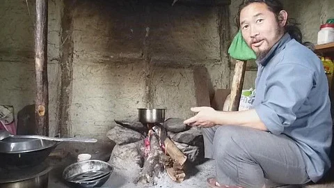 Tenzing Lepcha sits at the hearth of his farmstay. (Pic courtesy: Chicu)
