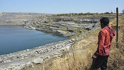 A villager looks at the changing landscape due to coal mines at Kosampalli village in Raigarh (Image source: IWP photo by Makarand Purohit)